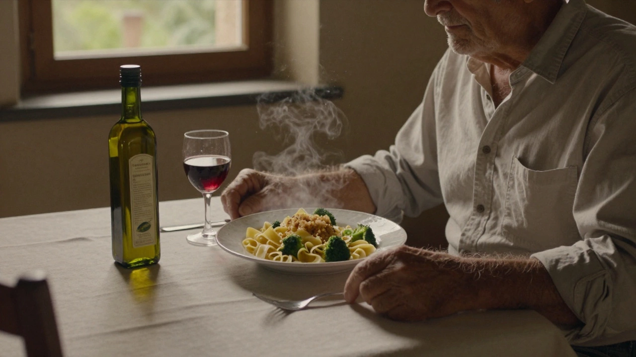 An elderly man eating pasta with broccoli and breadcrumbs at a quiet Umbrian dinner table.