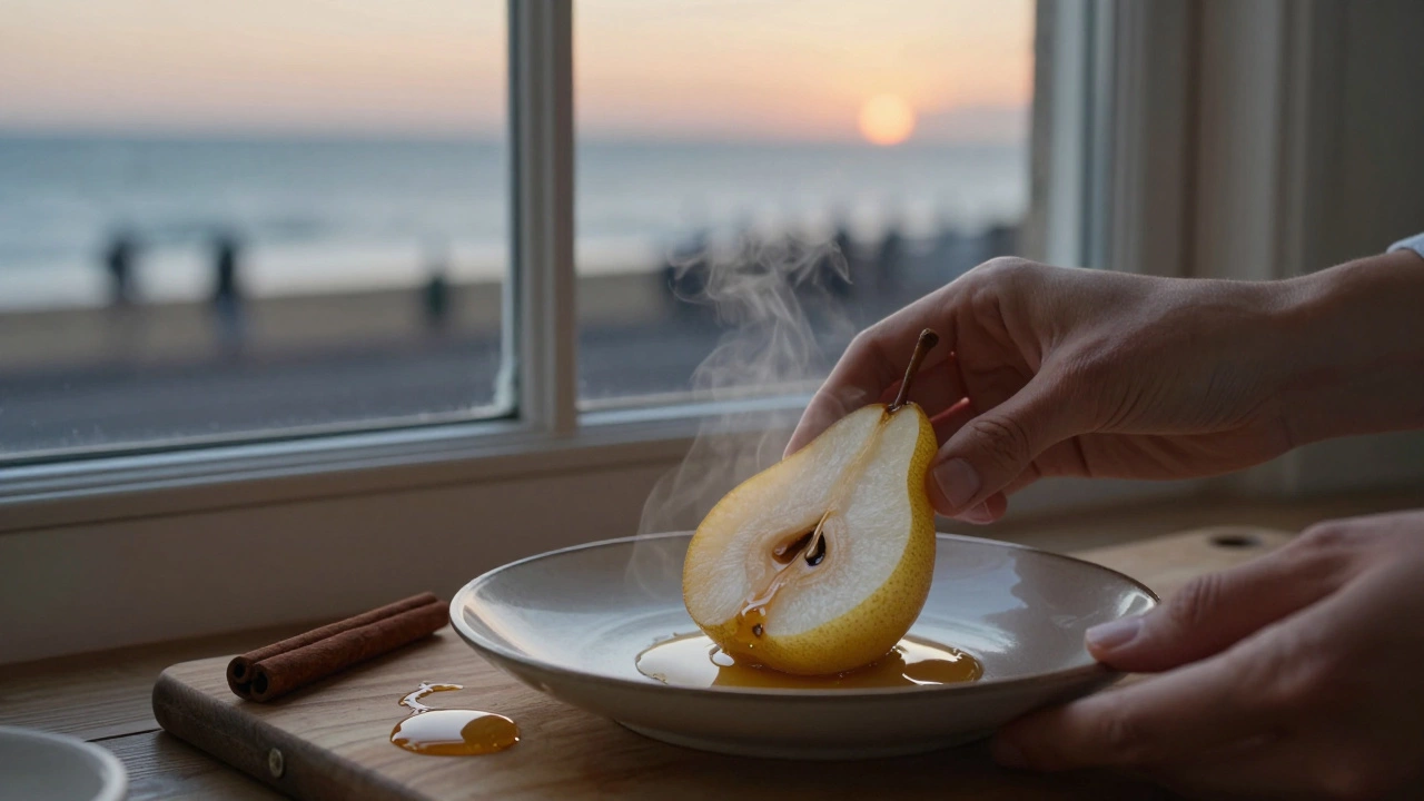 Hands placing a warm poached pear on a plate with cinnamon and honey nearby, twilight through a window.